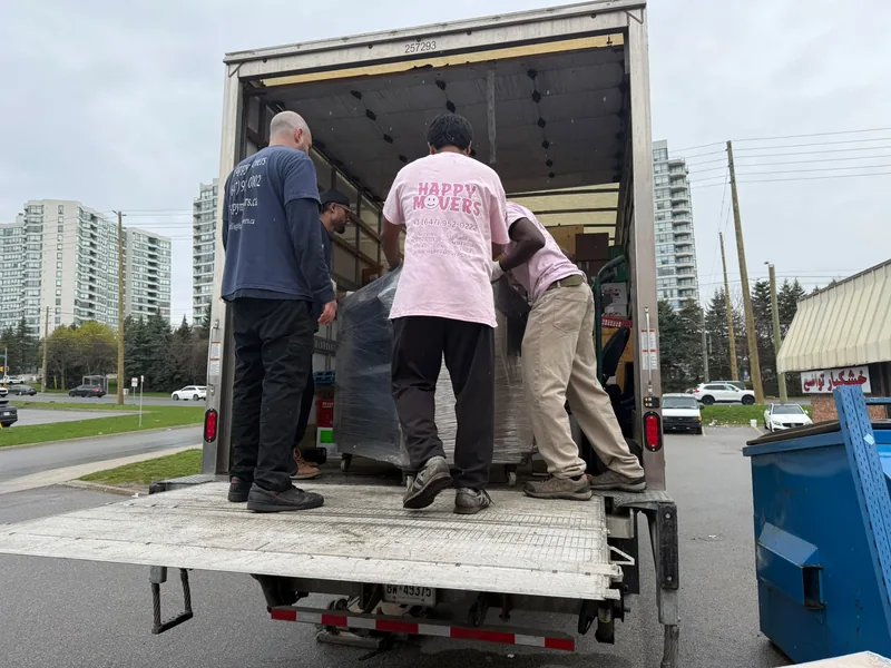 Moving crew loading office furniture and equipment into a truck