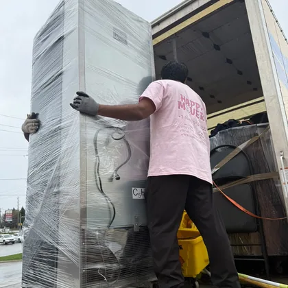 Crew member wrapping and preparing items for packing