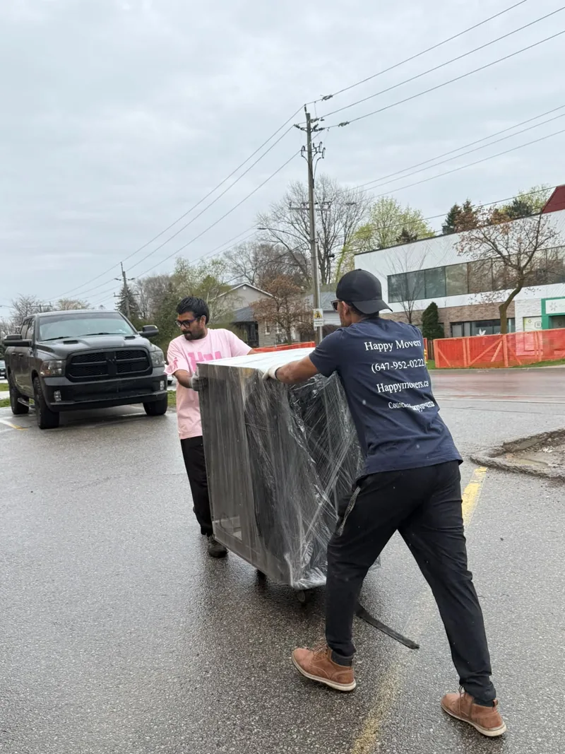 Mover loading unwanted items onto a dolly for removal