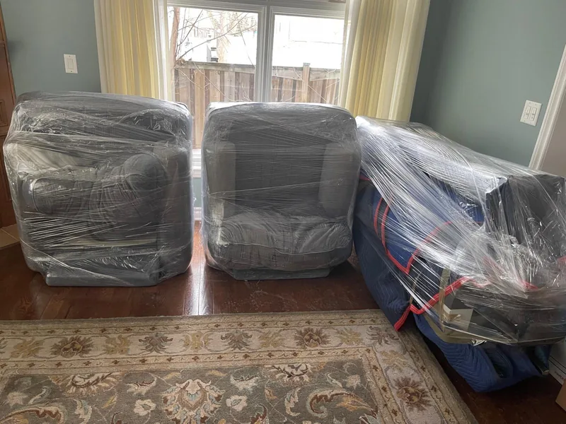 Living room furniture wrapped and protected before a residential move