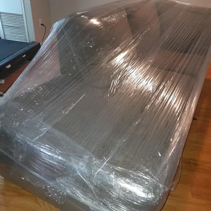 Sofa fully shrink-wrapped before being carried out
